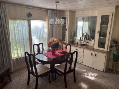 Spacious 2-bedroom, 2-bath home on a large corner lot with over on Zellwood Station Country Club in Florida - for sale on GolfHomes.com, golf home, golf lot