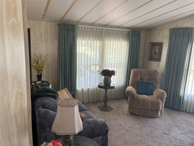 Spacious 2-bedroom, 2-bath home on a large corner lot with over on Zellwood Station Country Club in Florida - for sale on GolfHomes.com, golf home, golf lot