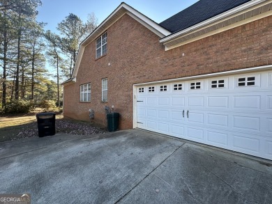 This solid 4-sided brick home is on the 14th hole of the fairway on Canongate On White Oak Golf Course in Georgia - for sale on GolfHomes.com, golf home, golf lot