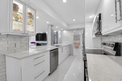 Discover luxury living in this beautifully renovated condo at on Boca West Golf and Country Club in Florida - for sale on GolfHomes.com, golf home, golf lot