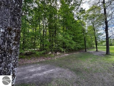 Go beyond the gated entrance, where a wooded winding drive on  in Michigan - for sale on GolfHomes.com, golf home, golf lot