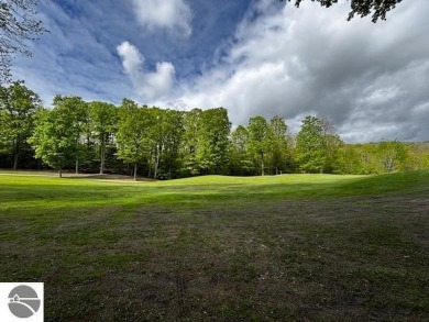 Go beyond the gated entrance, where a wooded winding drive on  in Michigan - for sale on GolfHomes.com, golf home, golf lot