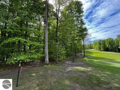 Go beyond the gated entrance, where a wooded winding drive on  in Michigan - for sale on GolfHomes.com, golf home, golf lot