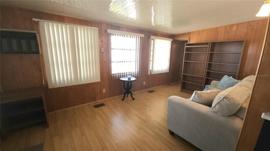 TWO BEDROOM, ONE BATHROOM MOBILE HOME IN AN ACTIVE 55+ COMMUNITY on River Run Golf Links in Florida - for sale on GolfHomes.com, golf home, golf lot