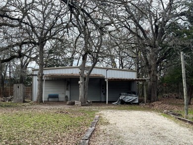 Already in place, 1200+- square foot metal workshop with a slab on Tawakoni Golf Course in Texas - for sale on GolfHomes.com, golf home, golf lot