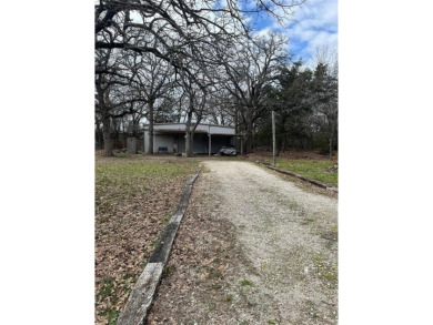 Already in place, 1200+- square foot metal workshop with a slab on Tawakoni Golf Course in Texas - for sale on GolfHomes.com, golf home, golf lot