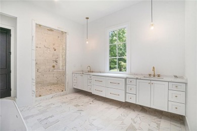 Set on a sprawling 1-acre lot in an established, tree-lined on Dunwoody Country Club in Georgia - for sale on GolfHomes.com, golf home, golf lot
