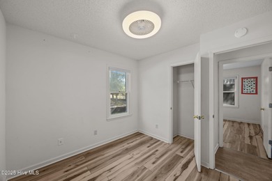 Tucked among the trees in the waterfront community of Fairfield on Harbour Point Golf Club in North Carolina - for sale on GolfHomes.com, golf home, golf lot