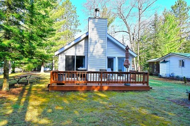 Step into rustic charm with this almost all-knotty pine interior on Birch Pointe Golf Club in Michigan - for sale on GolfHomes.com, golf home, golf lot