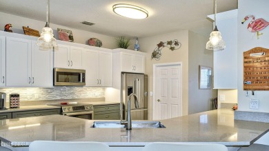 This stunning 4-bedroom saltwater pool home offers both elegance on Plantation Bay Golf and Country Club in Florida - for sale on GolfHomes.com, golf home, golf lot