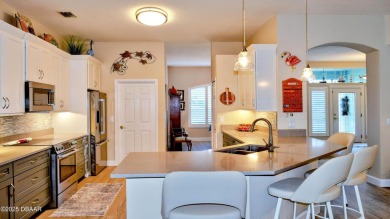 This stunning 4-bedroom saltwater pool home offers both elegance on Plantation Bay Golf and Country Club in Florida - for sale on GolfHomes.com, golf home, golf lot
