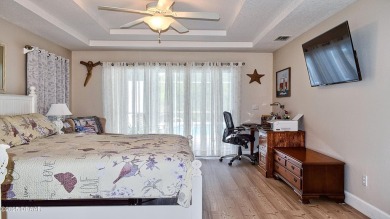 This stunning 4-bedroom saltwater pool home offers both elegance on Plantation Bay Golf and Country Club in Florida - for sale on GolfHomes.com, golf home, golf lot