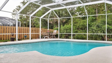 This stunning 4-bedroom saltwater pool home offers both elegance on Plantation Bay Golf and Country Club in Florida - for sale on GolfHomes.com, golf home, golf lot