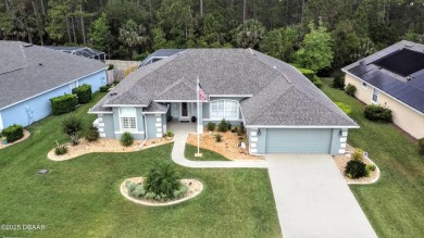 This stunning 4-bedroom saltwater pool home offers both elegance on Plantation Bay Golf and Country Club in Florida - for sale on GolfHomes.com, golf home, golf lot