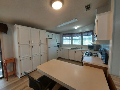 Air conditioned lanai & screened in porch are 2 ways to enjoy on Lakes at Leesburg Golf Course in Florida - for sale on GolfHomes.com, golf home, golf lot