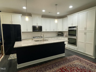 This lovely 5 bedroom, 3 full baths with a first floor primary on Olde Liberty Golf and Country Club in North Carolina - for sale on GolfHomes.com, golf home, golf lot