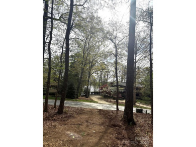 Discover the perfect setting for your forever home on this on Old North State Club at Uwharrie Point Golf community in North Carolina - for sale on GolfHomes.com, golf home, golf lot