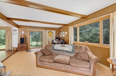 Step into this one-of-a-kind mid-century modern home tucked away on Kensington Metropark Golf Course in Michigan - for sale on GolfHomes.com, golf home, golf lot