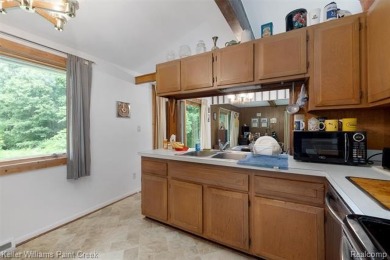 Step into this one-of-a-kind mid-century modern home tucked away on Kensington Metropark Golf Course in Michigan - for sale on GolfHomes.com, golf home, golf lot