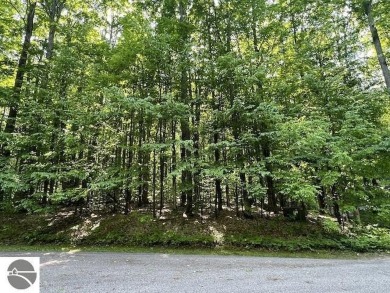 Towering hardwoods in a quiet cul-de-sac location and a large on Cedar River Golf Course in Michigan - for sale on GolfHomes.com, golf home, golf lot