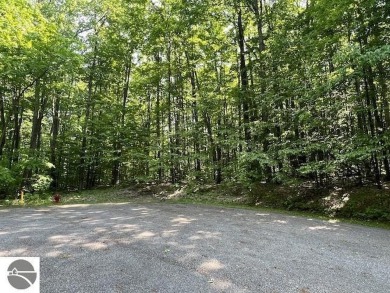 Towering hardwoods in a quiet cul-de-sac location and a large on Cedar River Golf Course in Michigan - for sale on GolfHomes.com, golf home, golf lot