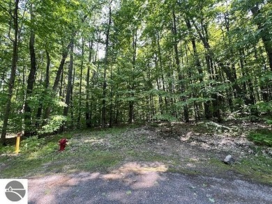 Towering hardwoods in a quiet cul-de-sac location and a large on Cedar River Golf Course in Michigan - for sale on GolfHomes.com, golf home, golf lot