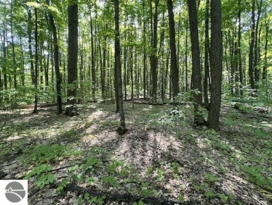 Towering hardwoods in a quiet cul-de-sac location and a large on Cedar River Golf Course in Michigan - for sale on GolfHomes.com, golf home, golf lot