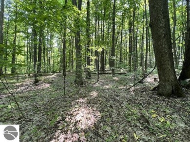 Towering hardwoods in a quiet cul-de-sac location and a large on Cedar River Golf Course in Michigan - for sale on GolfHomes.com, golf home, golf lot