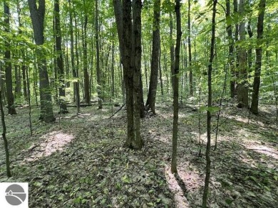 Towering hardwoods in a quiet cul-de-sac location and a large on Cedar River Golf Course in Michigan - for sale on GolfHomes.com, golf home, golf lot