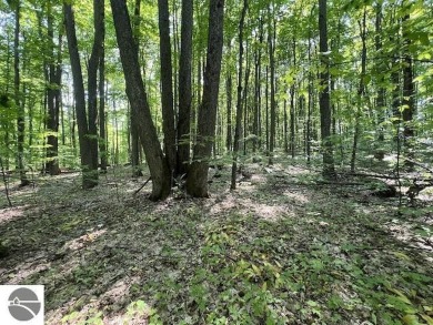 Towering hardwoods in a quiet cul-de-sac location and a large on Cedar River Golf Course in Michigan - for sale on GolfHomes.com, golf home, golf lot