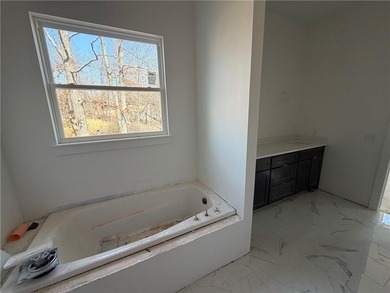 Kitchen has 2cm quartz & marble backsplash, along with stainless on Bella Vista - Metfield Golf Complex and Country Club in Arkansas - for sale on GolfHomes.com, golf home, golf lot