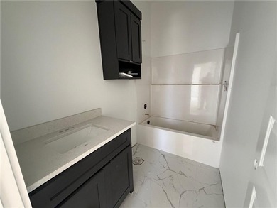 Kitchen has 2cm quartz & marble backsplash, along with stainless on Bella Vista - Metfield Golf Complex and Country Club in Arkansas - for sale on GolfHomes.com, golf home, golf lot