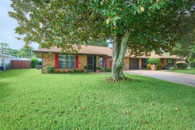 Nestled beneath a stunning magnolia tree in the front  a stately on Sun n Lake Golf and Country Club in Florida - for sale on GolfHomes.com, golf home, golf lot