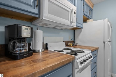 This studio condo offers stunning Lake Bellaire and sunset views on Shanty Creek Golf Course in Michigan - for sale on GolfHomes.com, golf home, golf lot