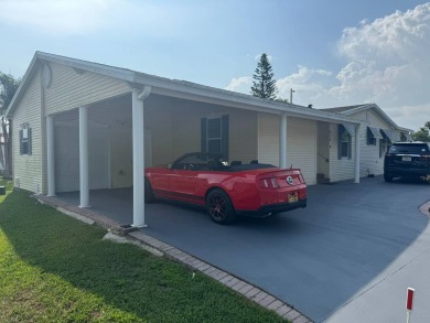 This one grabs your attention immediately as you approach the on Golden Lakes Golf Course in Florida - for sale on GolfHomes.com, golf home, golf lot