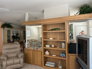 LIVING room is very spacious with bay windows, carpet flooring on Silver Dollar Golf and Trap Club in Florida - for sale on GolfHomes.com, golf home, golf lot