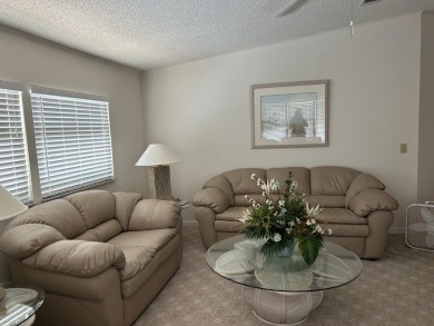 LIVING room is very spacious with bay windows, carpet flooring on Silver Dollar Golf and Trap Club in Florida - for sale on GolfHomes.com, golf home, golf lot