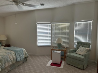 LIVING room is very spacious with bay windows, carpet flooring on Silver Dollar Golf and Trap Club in Florida - for sale on GolfHomes.com, golf home, golf lot