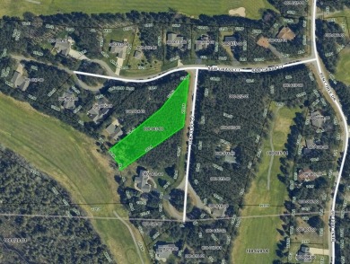 Escape to the beauty of Michaywe with this .9-acre wooded lot on Michaywe Pines Course in Michigan - for sale on GolfHomes.com, golf home, golf lot