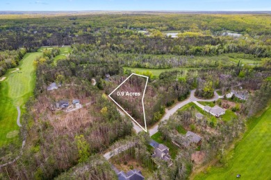 Escape to the beauty of Michaywe with this .9-acre wooded lot on Michaywe Pines Course in Michigan - for sale on GolfHomes.com, golf home, golf lot