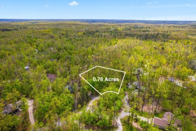Escape to the beauty of Michaywe with this .78-acre wooded lot on Michaywe Pines Course in Michigan - for sale on GolfHomes.com, golf home, golf lot