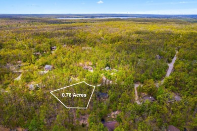 Escape to the beauty of Michaywe with this .78-acre wooded lot on Michaywe Pines Course in Michigan - for sale on GolfHomes.com, golf home, golf lot