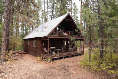 Among the serene wooded pines, this cozy, rustic cabin is a on Terrace Lakes Golf Resort in Idaho - for sale on GolfHomes.com, golf home, golf lot