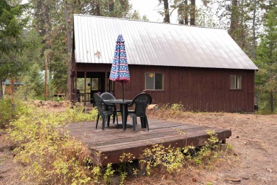 Among the serene wooded pines, this cozy, rustic cabin is a on Terrace Lakes Golf Resort in Idaho - for sale on GolfHomes.com, golf home, golf lot
