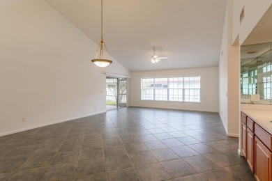 Vaulted ceilings and streaming natural light welcome you into on The Golf Club of Jupiter in Florida - for sale on GolfHomes.com, golf home, golf lot