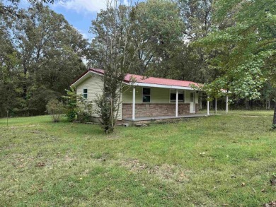 This property sits on 3 spacious lots with mature trees offering on The Course At Turkey Mountain in Arkansas - for sale on GolfHomes.com, golf home, golf lot