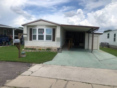 Located in the desirable gated, 55+ community this charming on Golden Lakes Golf Course in Florida - for sale on GolfHomes.com, golf home, golf lot