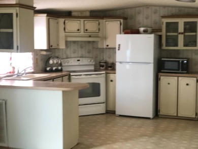 Located in the desirable gated, 55+ community this charming on Golden Lakes Golf Course in Florida - for sale on GolfHomes.com, golf home, golf lot