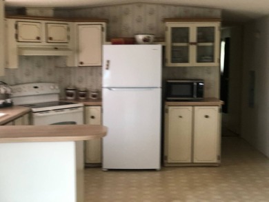 Located in the desirable gated, 55+ community this charming on Golden Lakes Golf Course in Florida - for sale on GolfHomes.com, golf home, golf lot