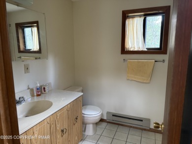 Spacious 3 bedroom home with fireplace and unfinished basement on Pocono Farms Country Club in Pennsylvania - for sale on GolfHomes.com, golf home, golf lot